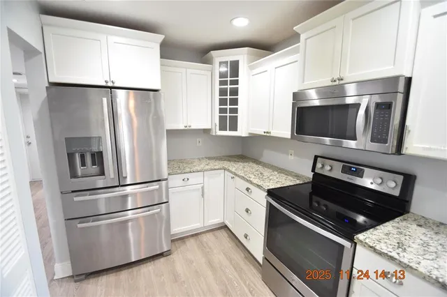 a kitchen with a refrigerator stove and microwave