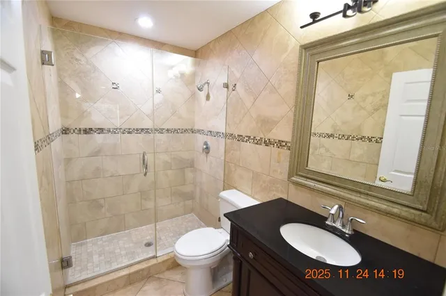 a bathroom with a sink toilet a mirror and shower