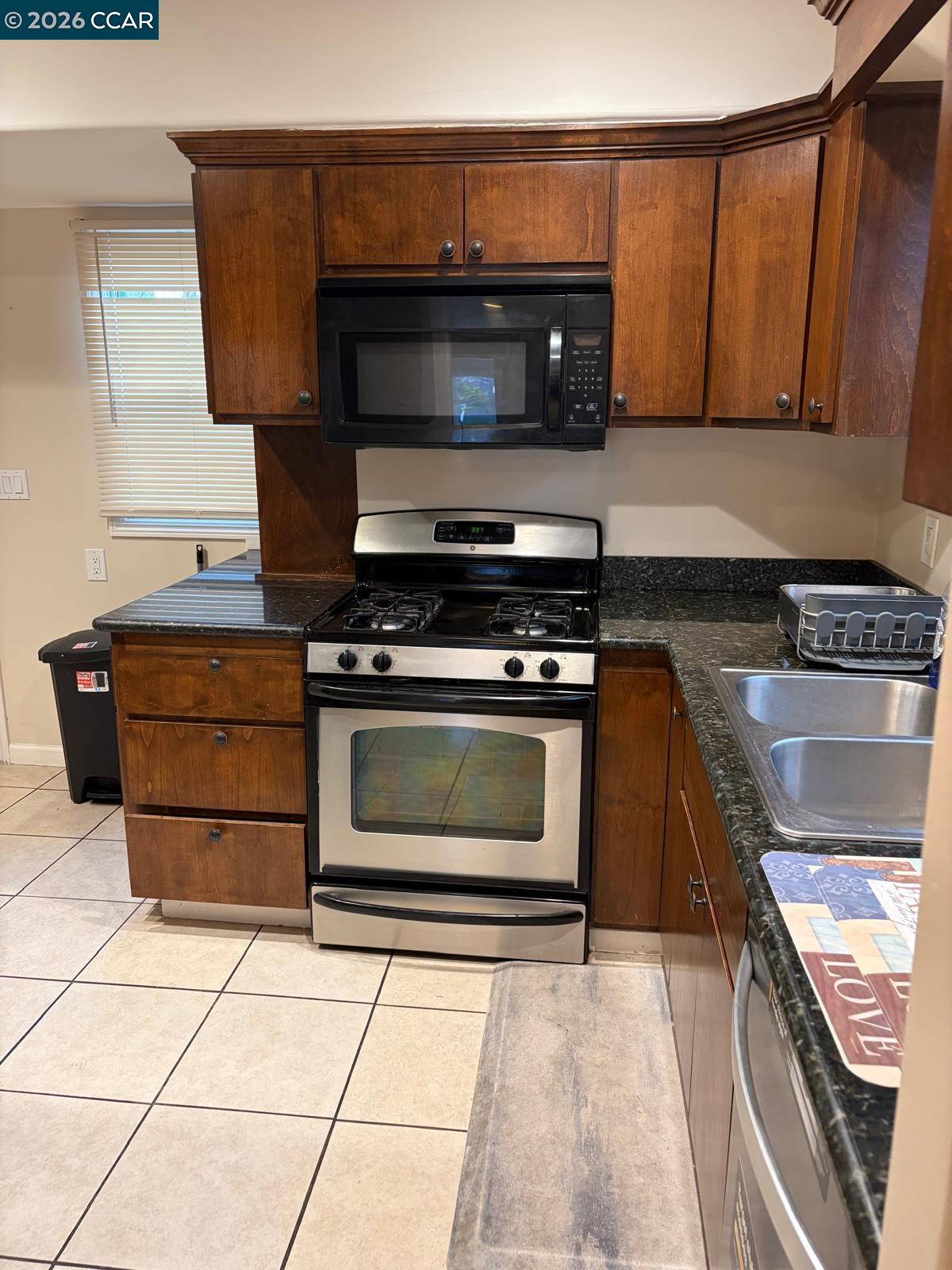 558 A Street Hayward, CA 94541 - Photo 8 of 9 a kitchen with granite countertop a stove and a microwave