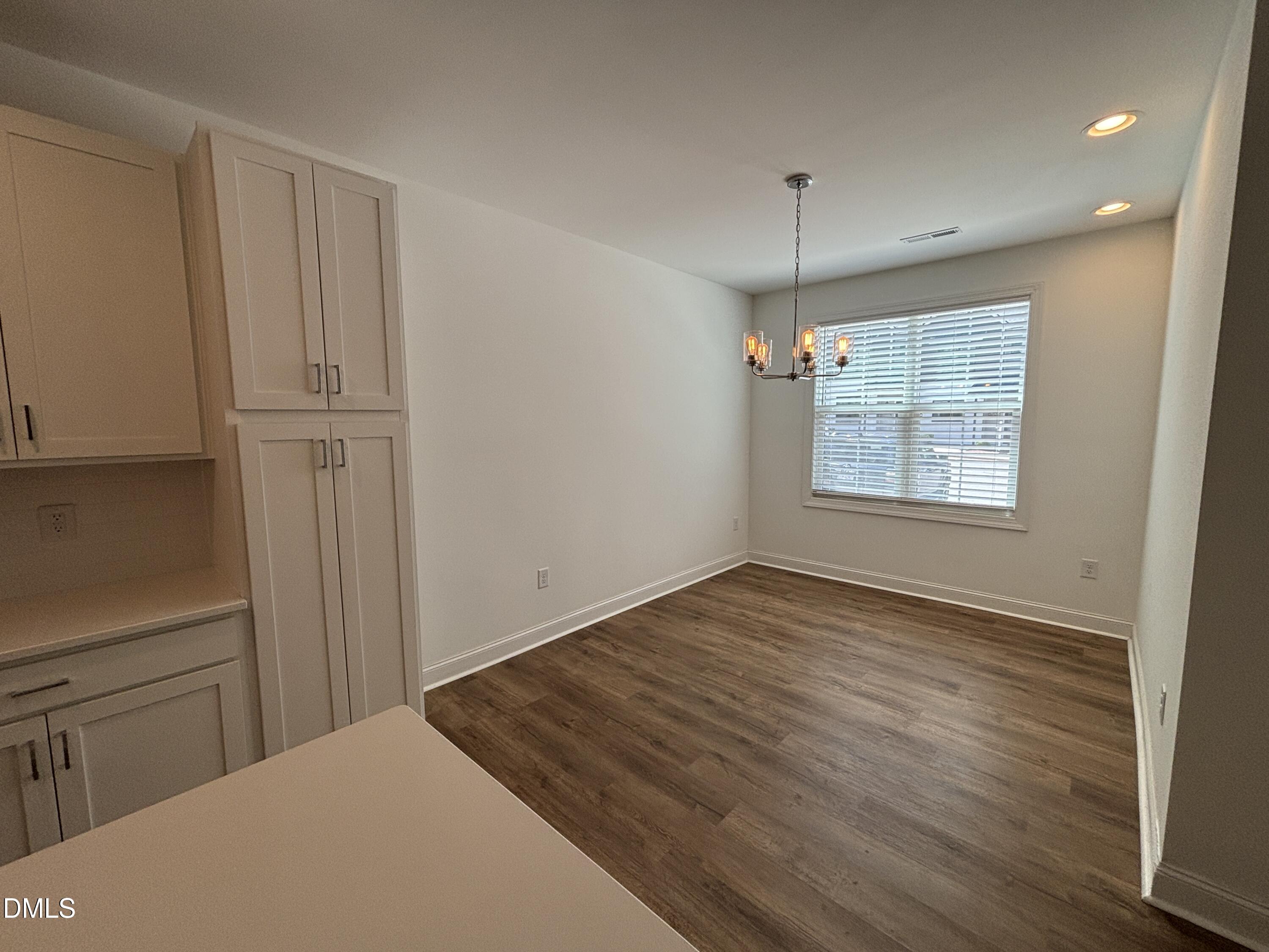 5710 Parker Pnes Court Raleigh, NC 27609 - Photo 15 of 78 a view of an empty room with window and wooden floor