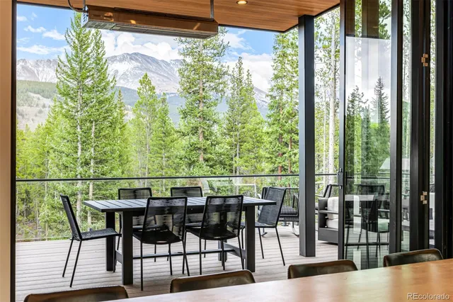 a view of a patio with a table chairs and a potted plant