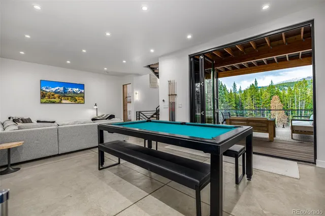 a room with pool table and windows