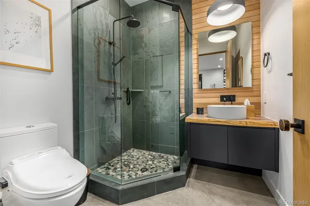 a bathroom with a toilet a sink and shower