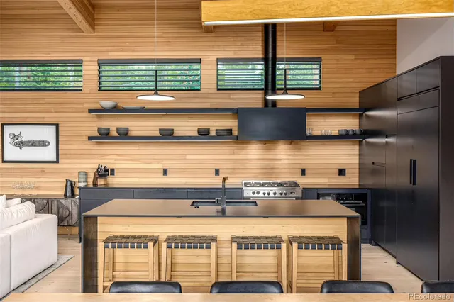 a kitchen with a table chairs and a large window