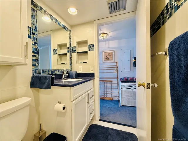 a bedroom with a bed and a chair