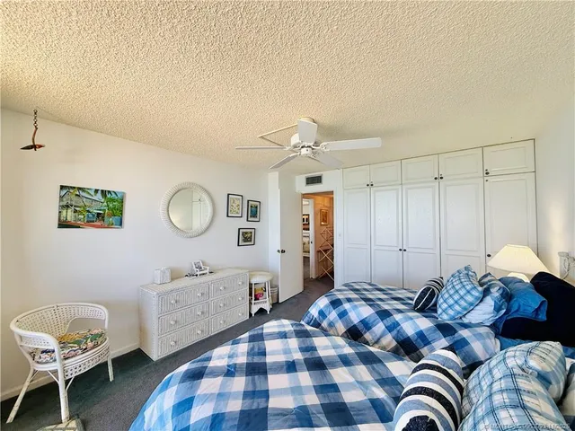 a bedroom with a bed and a curtain