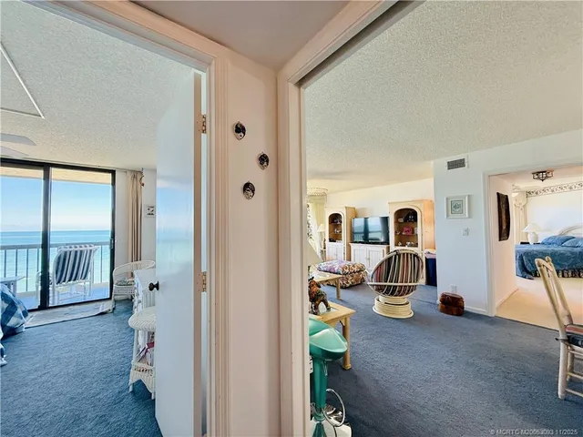 a living room with a bed furniture and a large window