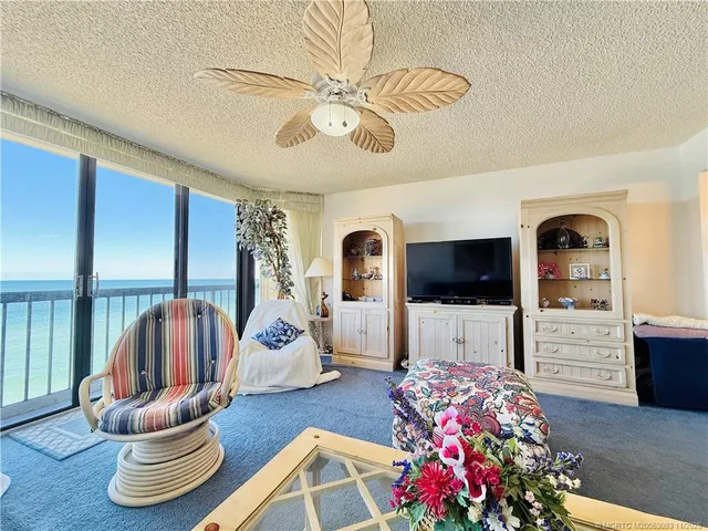 a room with lots of furniture and view of living room