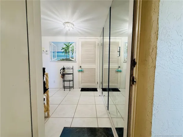 a kitchen with stainless steel appliances a refrigerator a stove top oven and a dining table with a large window