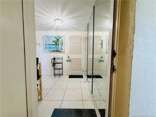 a kitchen with stainless steel appliances a refrigerator a stove top oven and a dining table with a large window