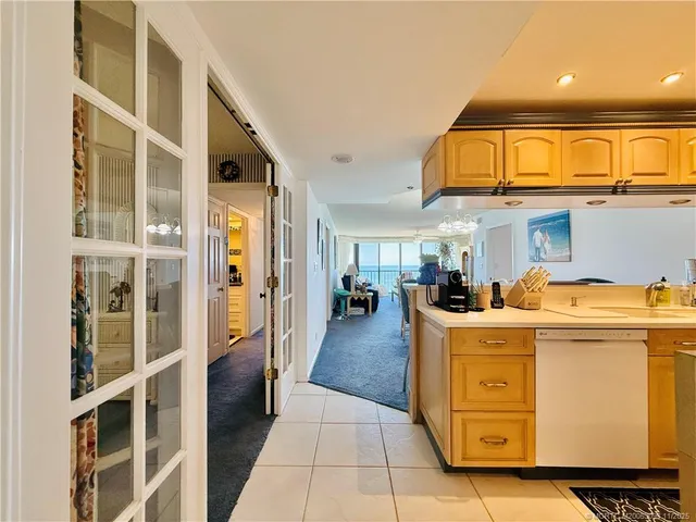 a kitchen with stainless steel appliances granite countertop a sink and dishwasher a refrigerator with wooden cabinets