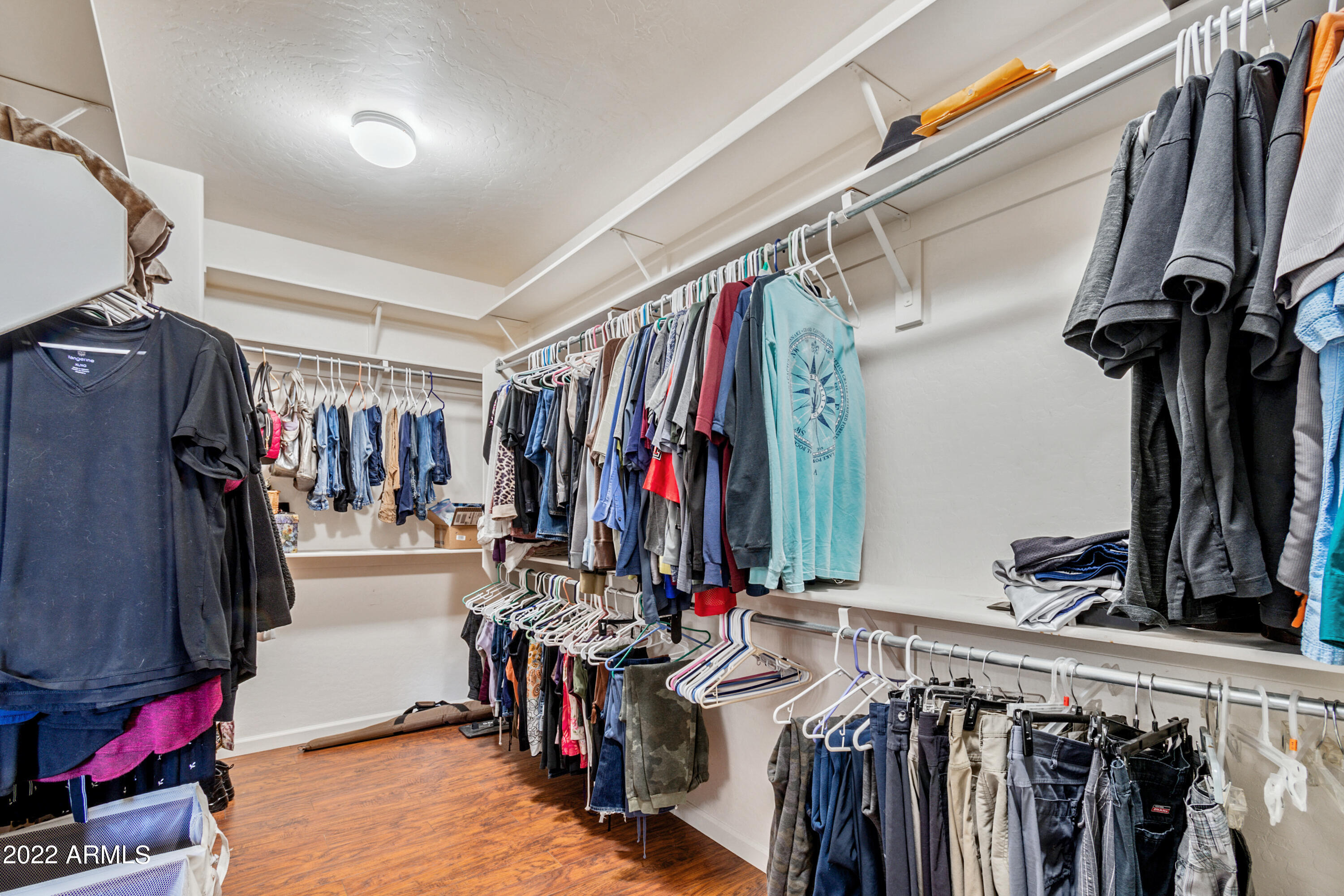 4633 East Timberline Road Gilbert, AZ 85297 - Photo 10 of 20 a view of walk in closet with clothes and shoes