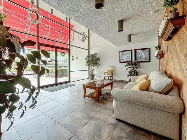 a living room with furniture and a potted plant