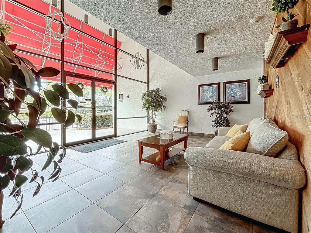 2579 Countryside Boulevard, Unit 203 Clearwater, FL 33761 - Photo 16 of 37 a living room with furniture and a potted plant