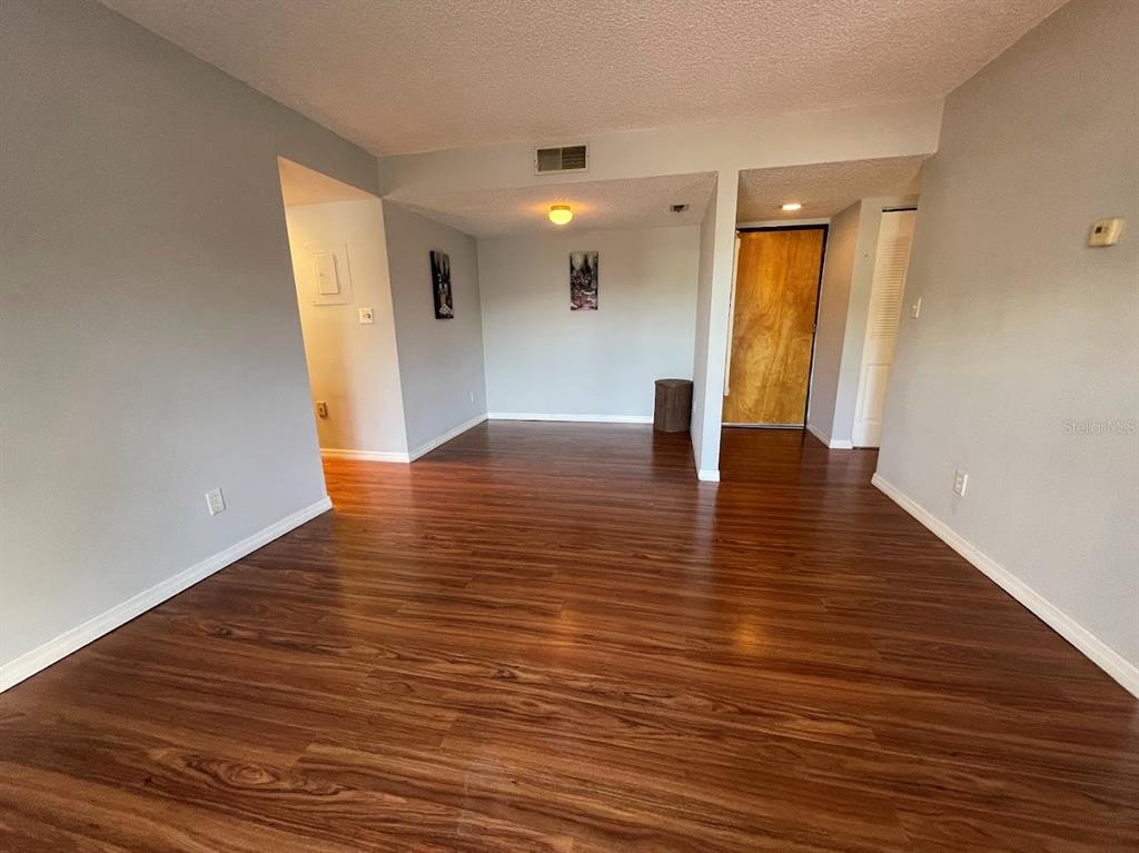 2579 Countryside Boulevard, Unit 203 Clearwater, FL 33761 - Photo 21 of 37 a view of an empty room with wooden floor and a window