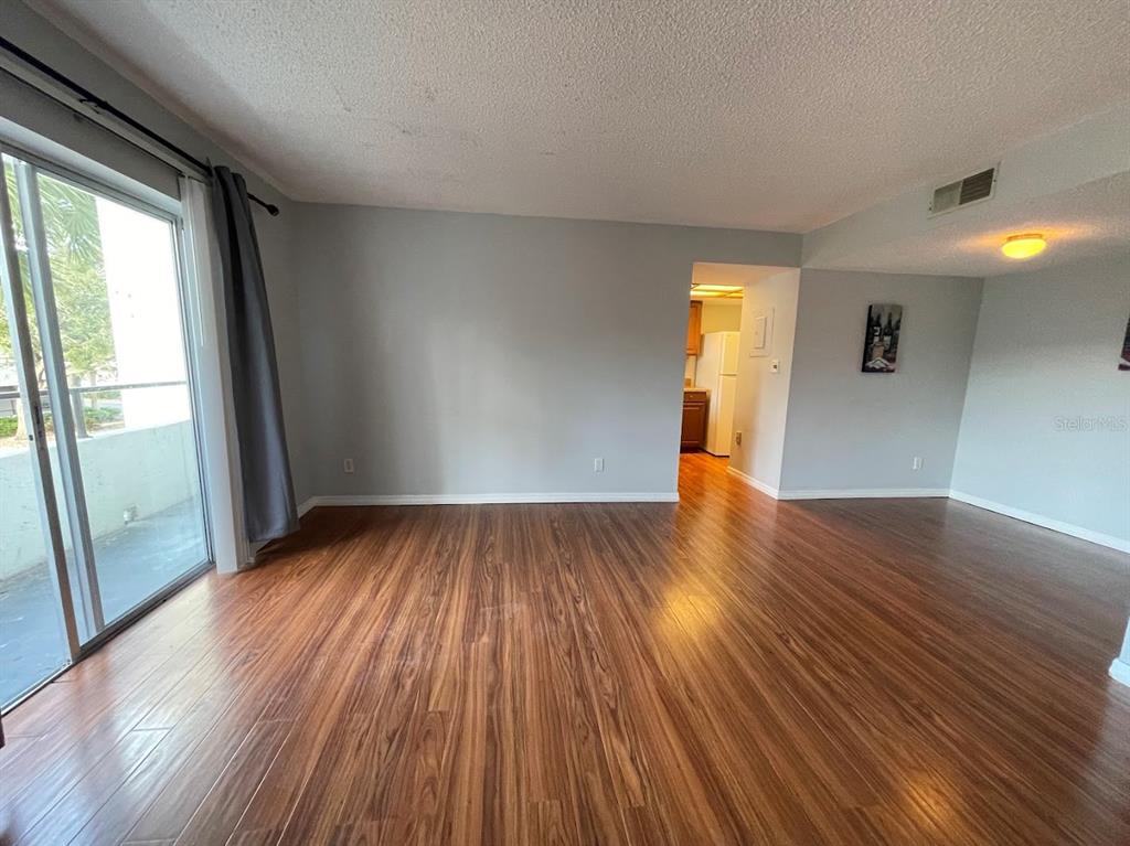 2579 Countryside Boulevard, Unit 203 Clearwater, FL 33761 - Photo 24 of 37 a view of empty room with wooden floor and fan