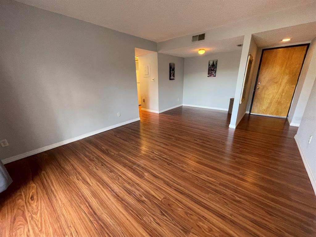 2579 Countryside Boulevard, Unit 203 Clearwater, FL 33761 - Photo 25 of 37 a view of a room with wooden floor and staircase