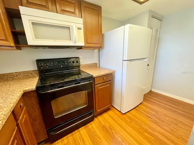 a kitchen with sink a window and cabinets
