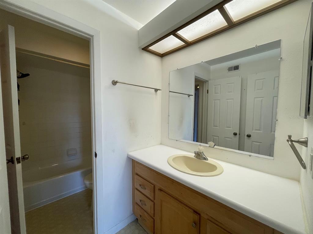 2579 Countryside Boulevard, Unit 203 Clearwater, FL 33761 - Photo 31 of 37 a bathroom with a sink and a mirror