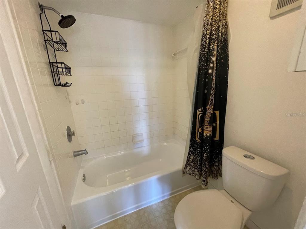 2579 Countryside Boulevard, Unit 203 Clearwater, FL 33761 - Photo 33 of 37 a bathroom with a toilet and a shower