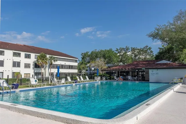 a view of swimming pool with outdoor seating and plants