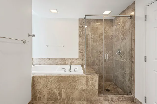 a bathroom with a bathtub and shower