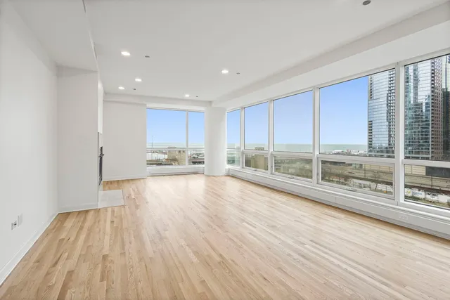 a view of wooden floor and windows in a room