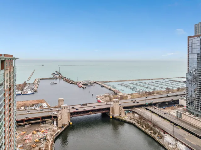 a view of roof deck with table and chairs