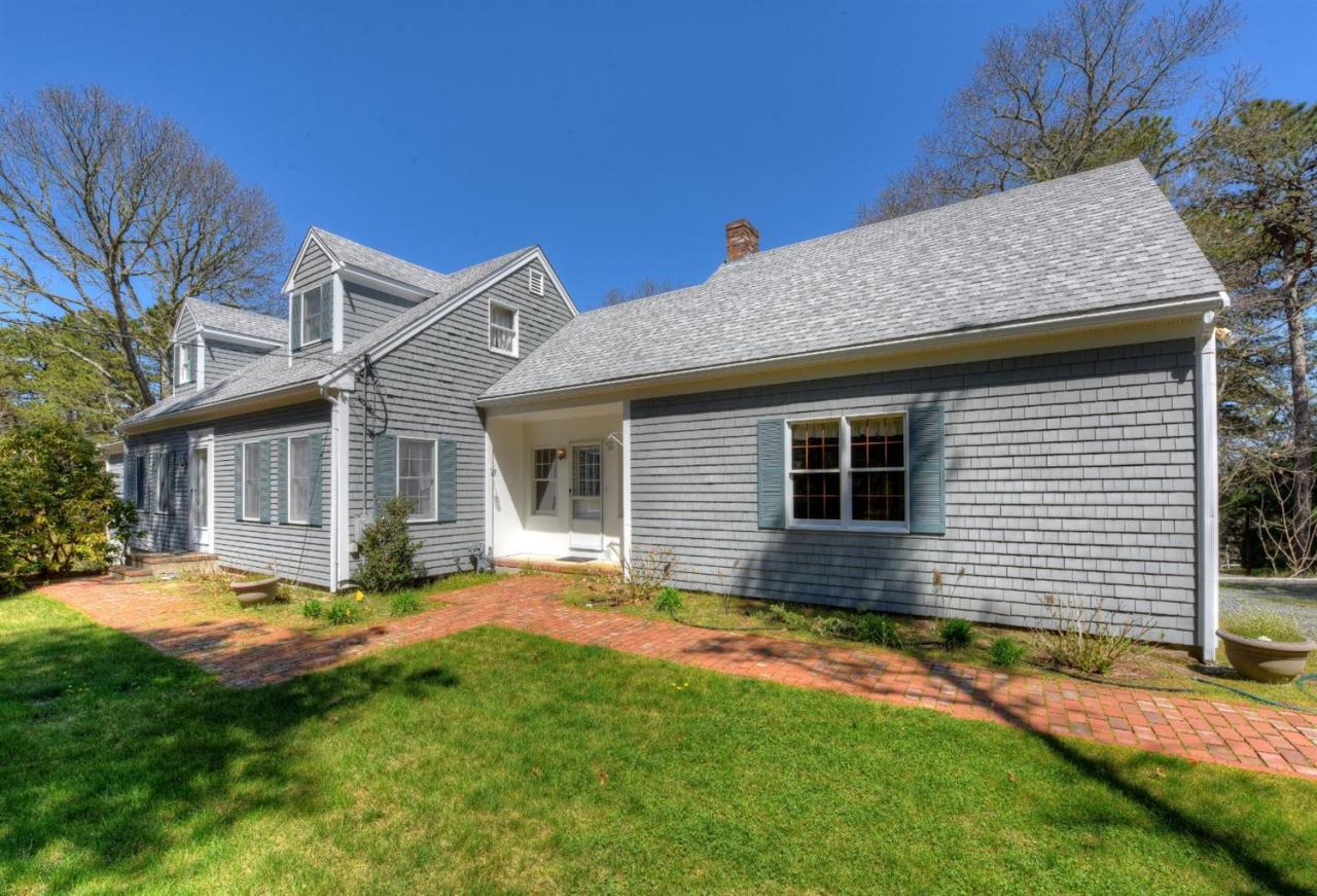 923 Old Post Road Cotuit, MA 02635 - Photo 1 of 35 a view of a house with a yard and plants