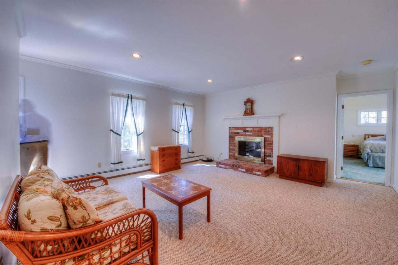 923 Old Post Road Cotuit, MA 02635 - Photo 17 of 35 a living room with furniture and a fireplace