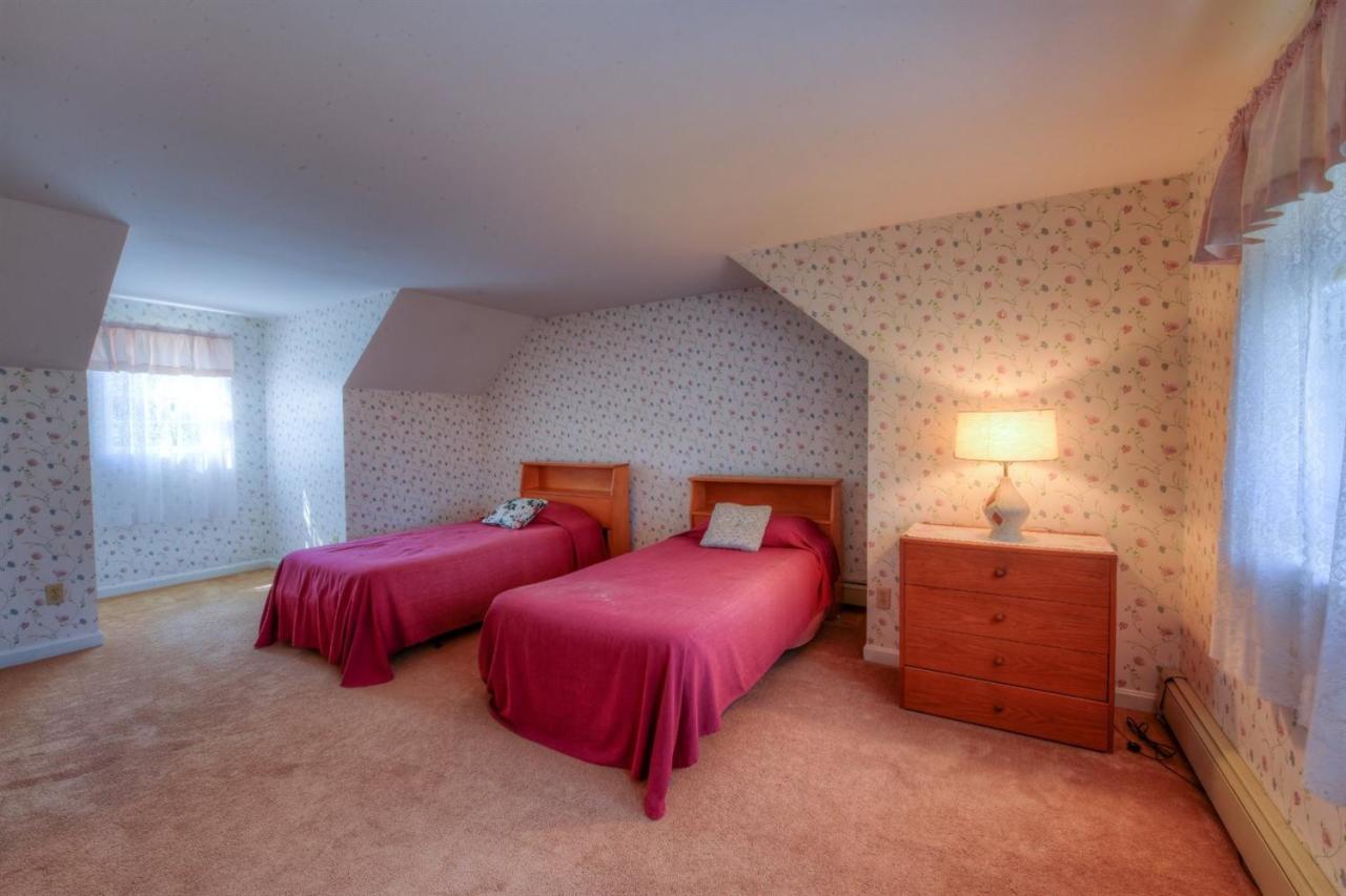 923 Old Post Road Cotuit, MA 02635 - Photo 24 of 35 a bedroom with two beds and painted walls