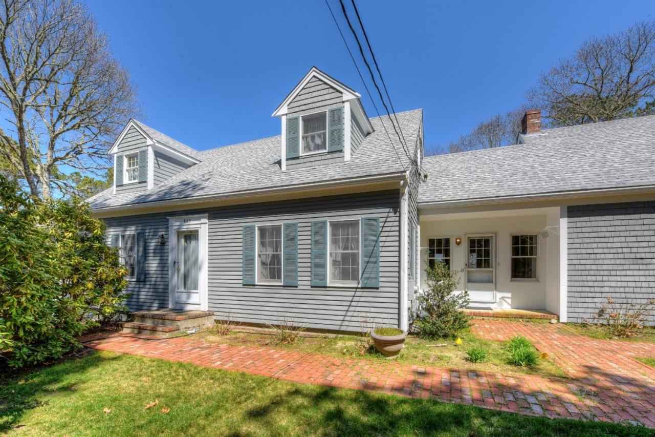 923 Old Post Road Cotuit, MA 02635 - Photo 3 of 35 a view of a house with brick walls and a yard with plants
