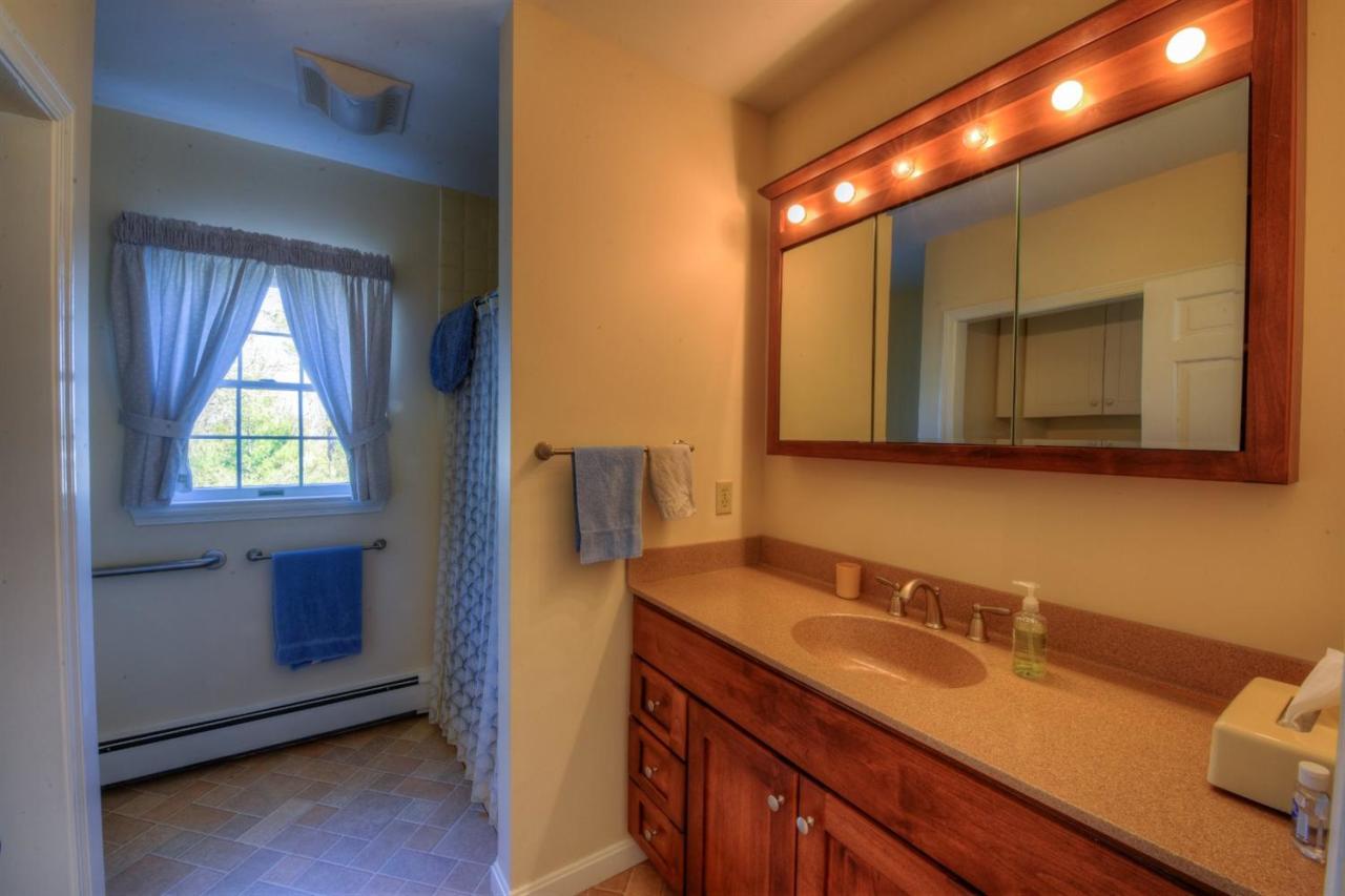 923 Old Post Road Cotuit, MA 02635 - Photo 10 of 35 a bathroom with a sink and a mirror