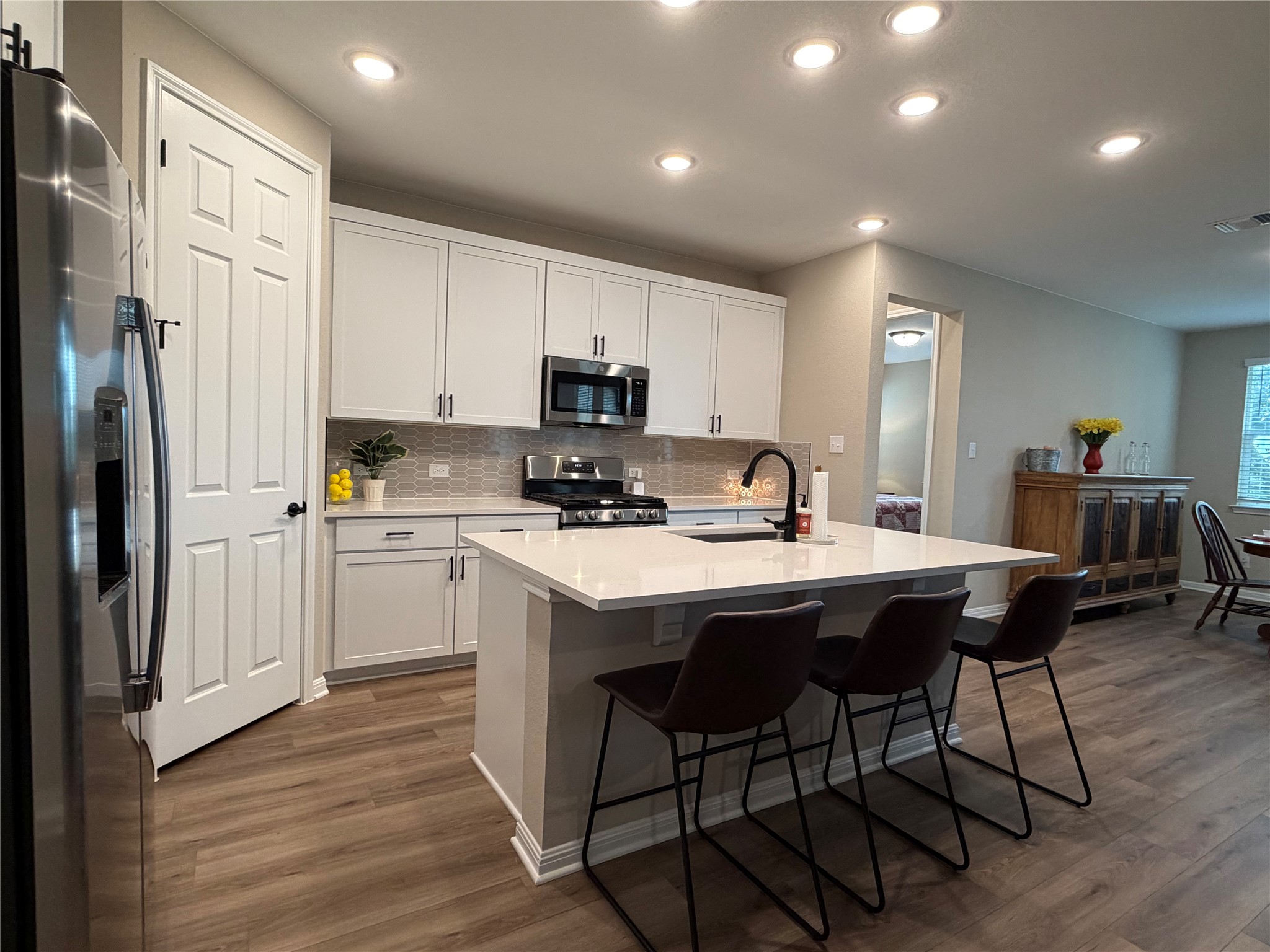 549 Raleigh Drive Georgetown, TX 78633 - Photo 23 of 29 a kitchen with stainless steel appliances granite countertop a sink a stove a refrigerator and cabinets