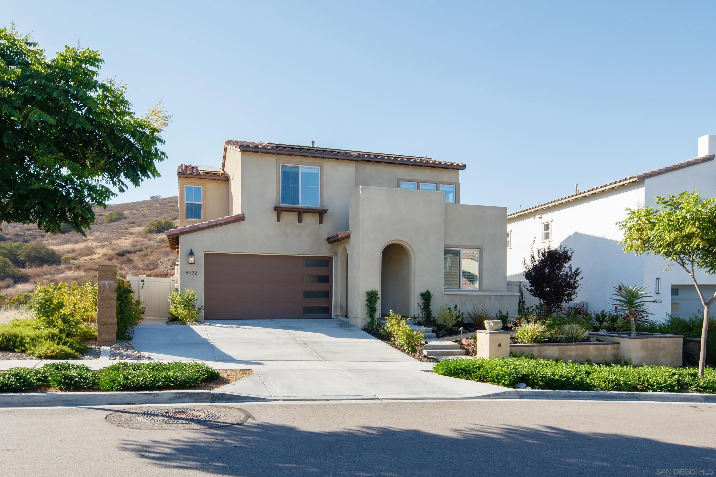 8932 Hightail Drive Santee, CA 92071 - Photo 3 of 20 a front view of a house with a garden and plants