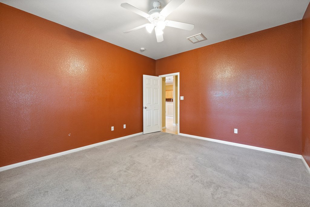 347 Spring Drive Kyle, TX 78640 - Photo 29 of 40 A versatile room featuring textured walls and soft carpet, ready for your personal touch.