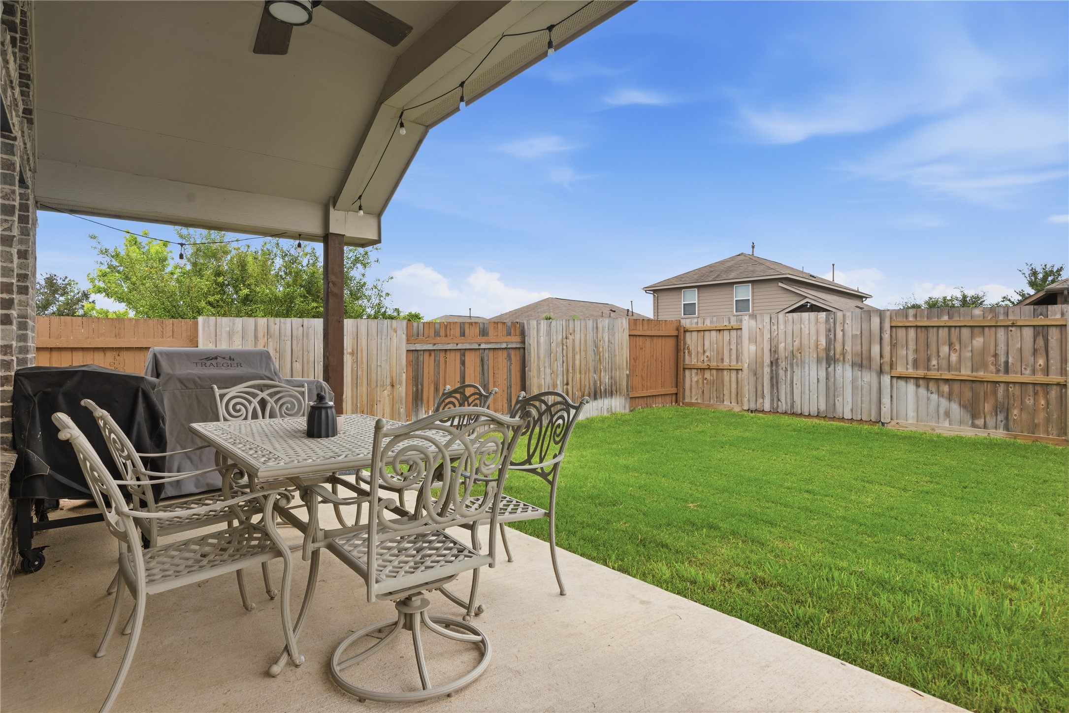 486 Pond View Pass Buda, TX 78610 - Photo 34 of 39 Covered patio featuring a ceiling fan, string lighting, and a concrete surface