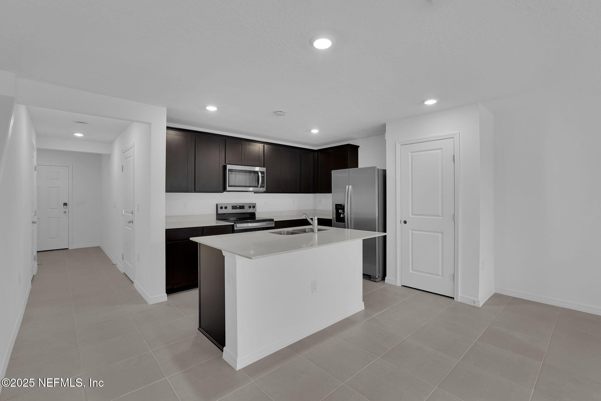1916 Normandy Pines Lane Jacksonville, FL 32221 - Photo 5 of 21 a kitchen with stainless steel appliances kitchen island sink refrigerator and cabinets