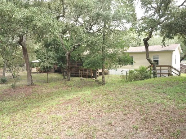 a view of a field with an trees in the background