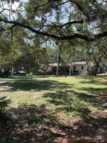 a view of a field with an ocean view