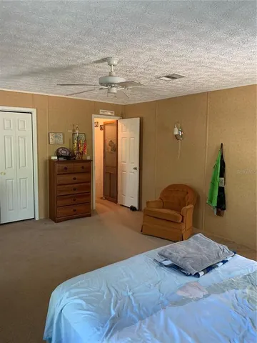 a view of a hallway with a cabinet and a window