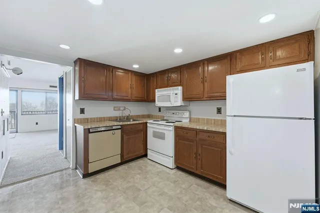 a kitchen with cabinets a refrigerator and a stove top oven