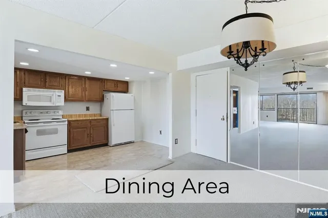 a kitchen with stainless steel appliances granite countertop a sink a refrigerator and a stove