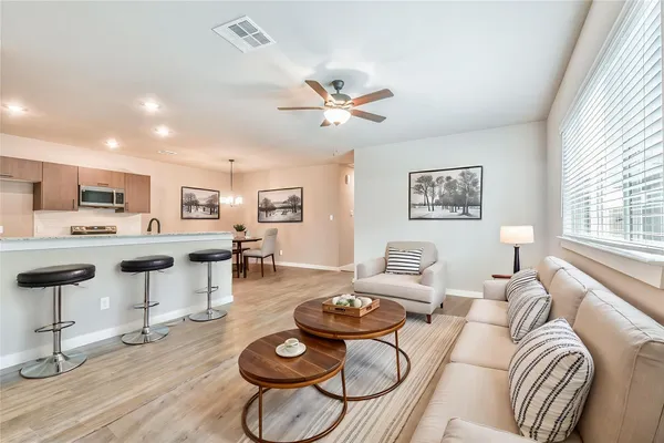 a living room with furniture and kitchen view
