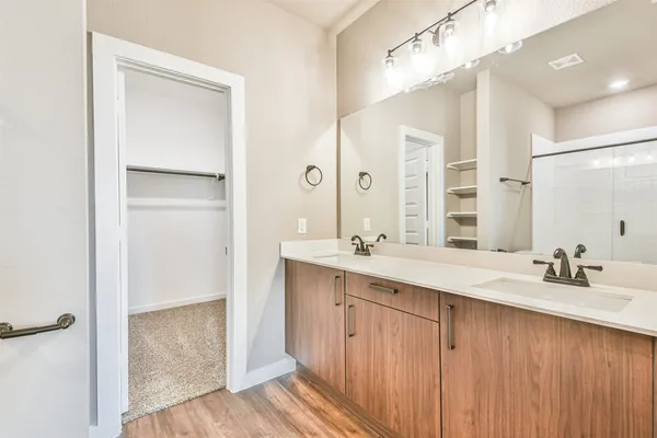 a bathroom with a double vanity sink mirror and