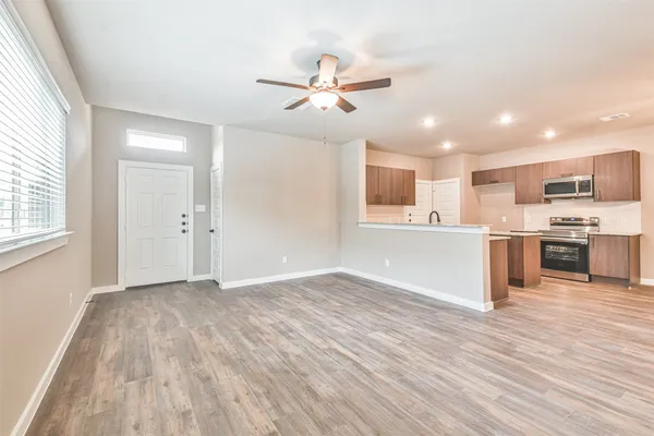 a view of kitchen with sink and wooden floor