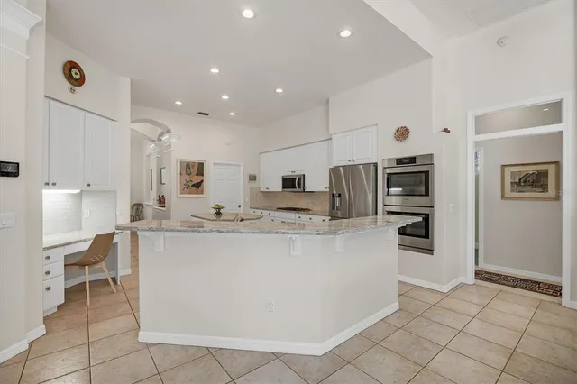 a spacious bathroom with a double vanity sink a mirror and a bathtub