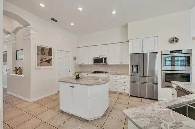 a large bathroom with a double vanity sink a mirror and a bathtub