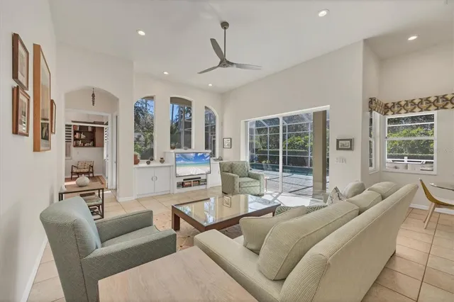 a living room with furniture a window and bookshelf