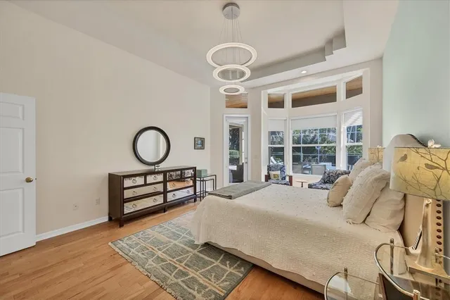 an aerial view of residential houses with outdoor space and trees